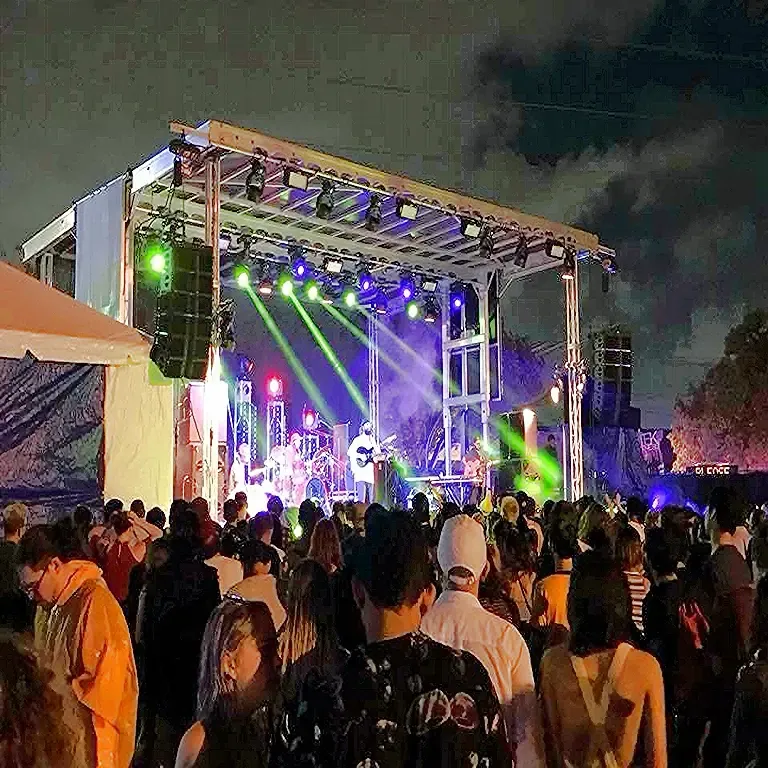 Night crowd in front of a compact APEX stage